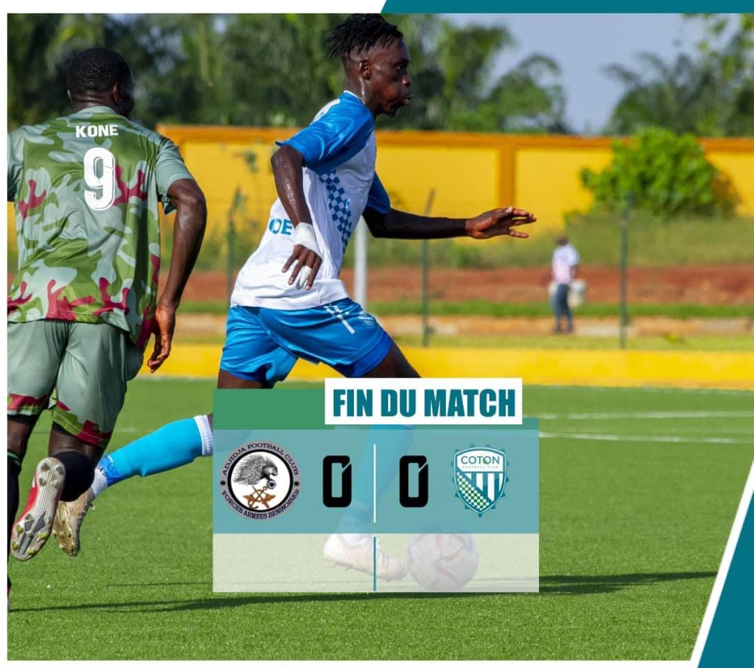 Deux joueurs de football en action sur un terrain avec un score nul 0-0 affiché en surimpression